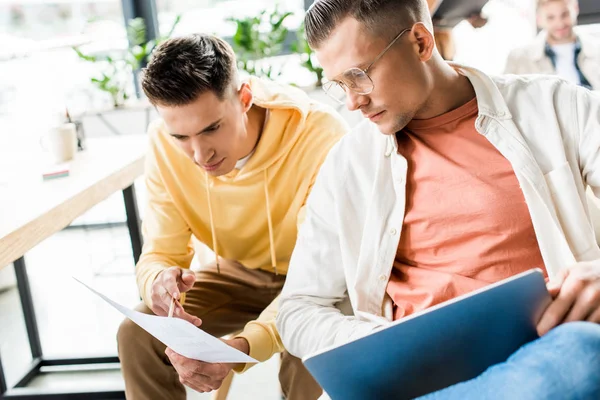 Two young businessmen discussing startup project together in office — Stock Photo