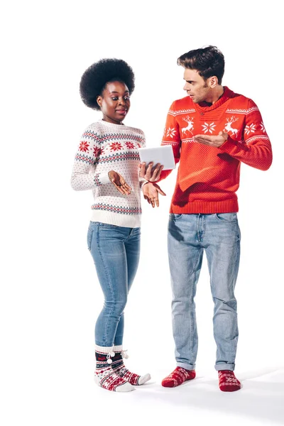 Confused young interracial couple using digital tablet, isolated on white — Stock Photo