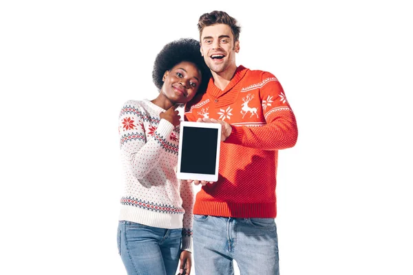 Young interracial couple showing digital tablet with blank screen, isolated on white — Stock Photo