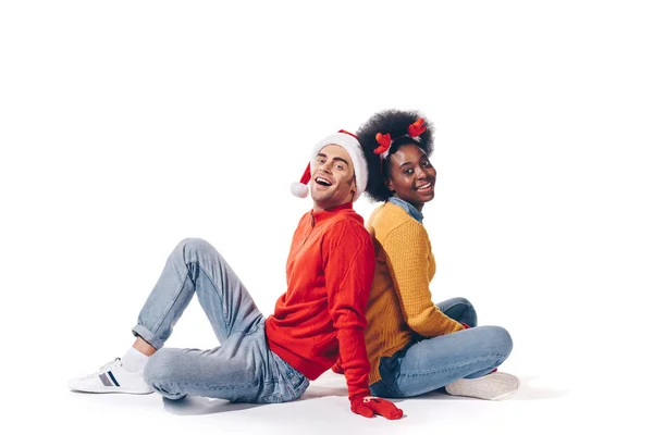 Happy interracial couple in santa hat and deer horns, isolated on white — Stock Photo