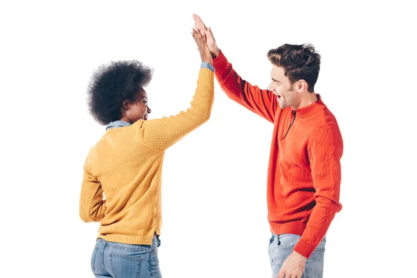 Happy interracial couple in winter clothes giving highfive, isolated on white — Stock Photo