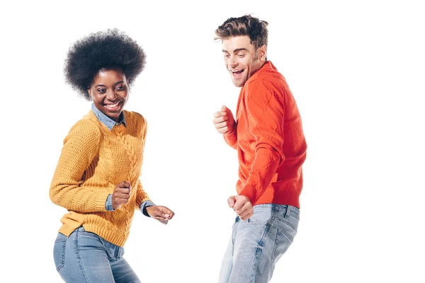 Cheerful multiethnic couple dancing, isolated on white — Stock Photo