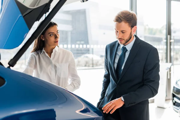 Selective focus of attractive woman looking at bearded man in formal wear — Stock Photo