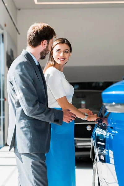 Enfoque selectivo de la mujer alegre mirando al hombre barbudo - foto de stock