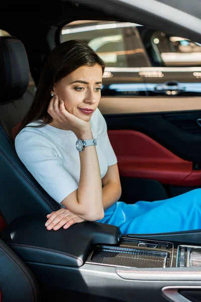 Upset woman sitting in new modern car — Stock Photo
