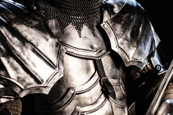 Cropped view of knight in armor isolated on black — Stock Photo