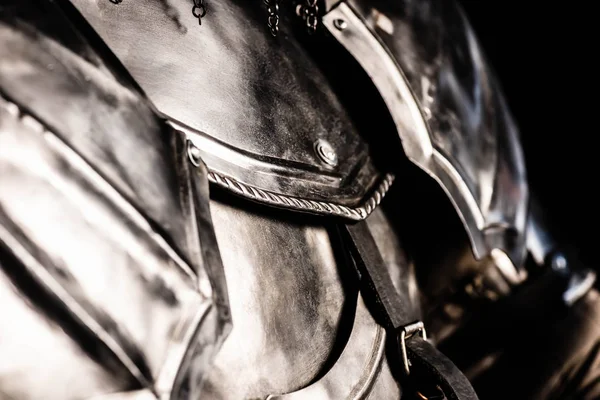 Cropped view of knight in armor isolated on black — Stock Photo