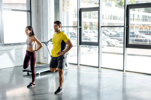 Sportsman and sportswoman working out together in sports center — Stock Photo