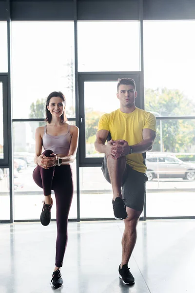 Deportista y deportista haciendo ejercicio juntos en el centro deportivo - foto de stock