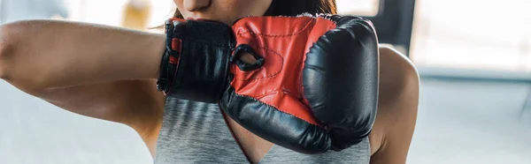 Panoramic shot of sportswoman in boxing glove in sports center — Stock Photo