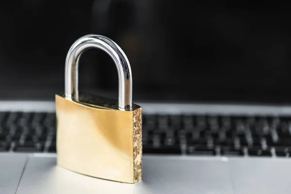 Selective focus of metal padlock on digital device in office — Stock Photo