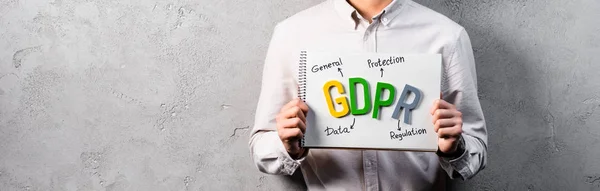 Panoramic shot of businessman holding paper with gdpr lettering — Stock Photo