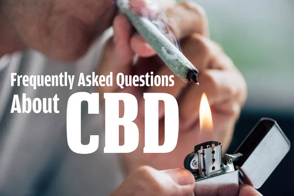 Cropped view of man lighting up blunt with medical cannabis and frequently asked questions about cbd illustration — Stock Photo