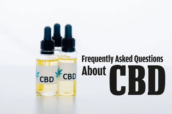 Cbd oil in bottles isolated on white with frequently asked questions about cbd illustration — Stock Photo