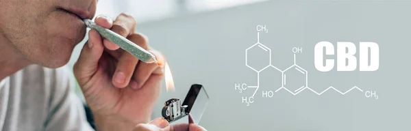 Vista recortada del hombre iluminando contundente con cannabis medicinal, tiro panorámico con ilustración de molécula de cbd - foto de stock
