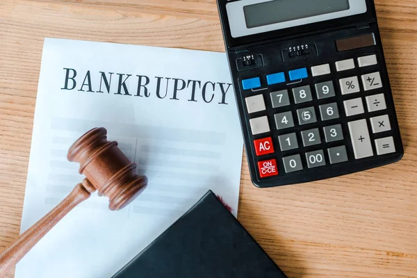 Top view of document with bankruptcy letters near calculator and gavel — Stock Photo