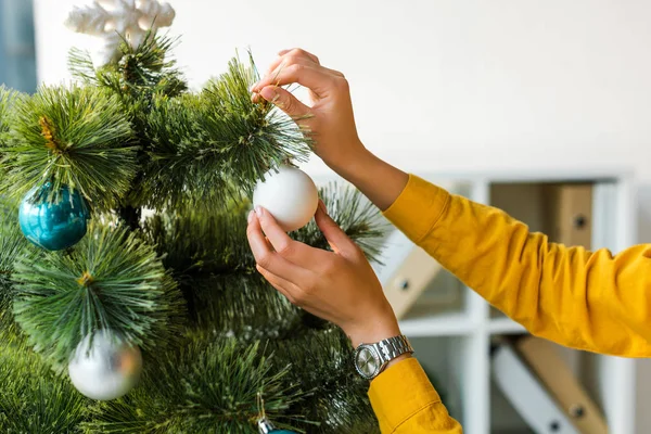 Vista ritagliata della donna decorazione albero di Natale in ufficio — Foto stock