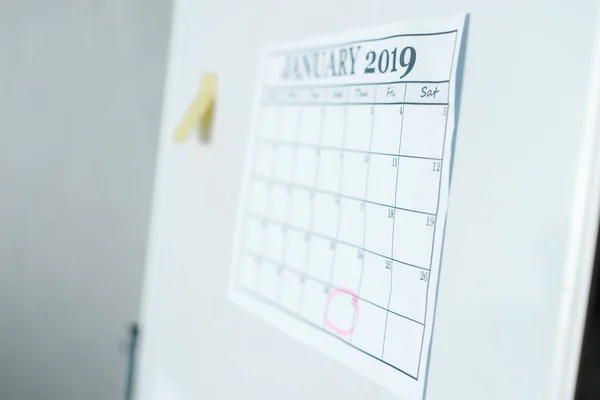 Selective focus of calendar with january lettering on flipboard — Stock Photo