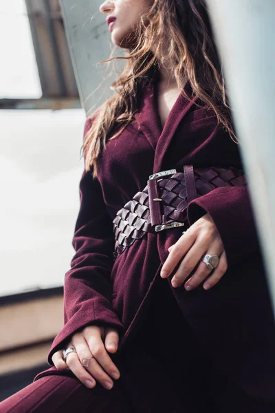 Cropped view of fashionable girl posing in trendy burgundy suit on urban roof — Stock Photo