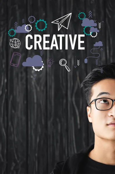 Cropped view of asian man in glasses looking at illustration with creative lettering — Stock Photo