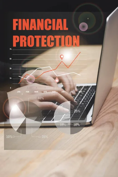 Cropped view of hacker using laptop and financial protection illustration — Stock Photo