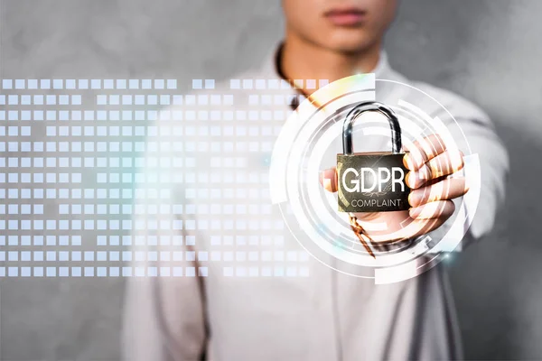 Cropped view of businessman holding metal padlock with gdpr lettering and illustration — Stock Photo