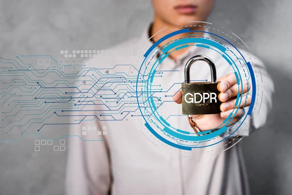 Cropped view of businessman holding metal padlock with gdpr lettering and illustration — Stock Photo