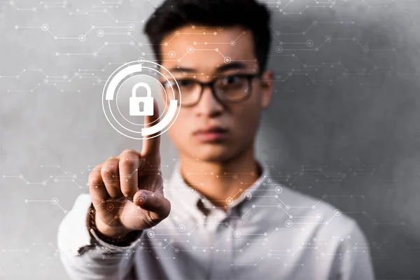 Selective focus of asian businessman touching padlock illustration — Stock Photo