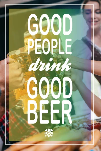 Partial view of friends clinking mugs of light and dark beer with good people drink good beer illustration — Stock Photo