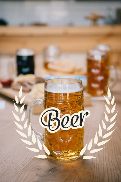 Selective focus of mug with lager and beer illustration on wooden table — Stock Photo