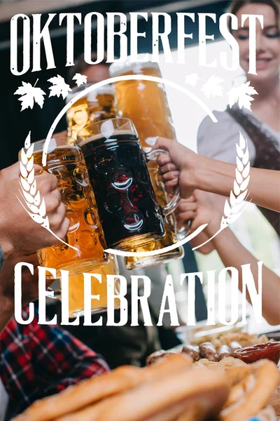 Partial view of friends clinking mugs of light and dark beer  with Oktoberfest celebration illustration — Stock Photo