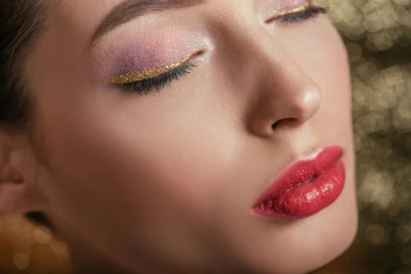 Close up view of beautiful woman with shiny makeup and closed eyes — Stock Photo