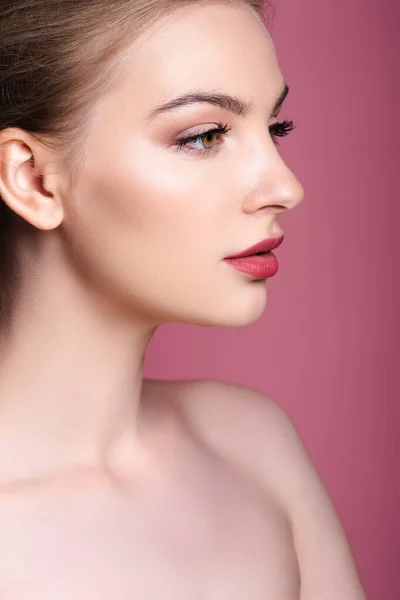 Nude and young woman with makeup looking away on pink — Stock Photo