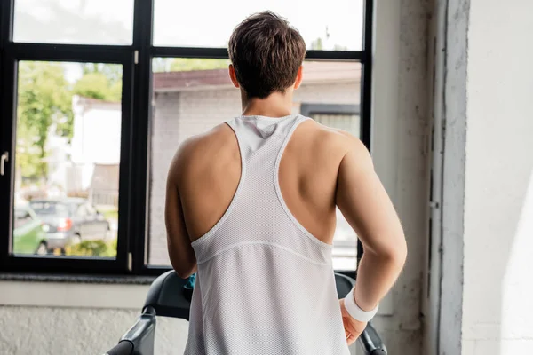 Back view of sportsman running on treadmill — Stock Photo