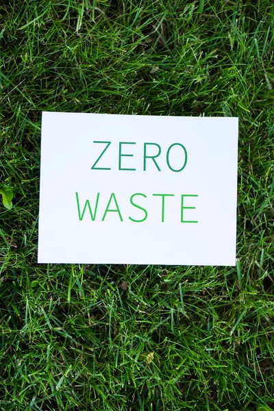 Top view of card with zero waste words on grass, ecology concept — Stock Photo