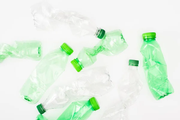 Top view of crumpled plastic bottles on white surface, ecology concept — Stock Photo