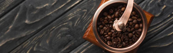 Draufsicht auf alte Kaffeemühle mit Kaffeebohnen auf Holzoberfläche, Panoramaaufnahme — Stockfoto