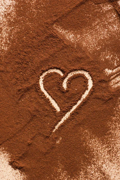 Top view of heart drawn on ground coffee — Stock Photo