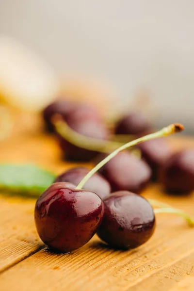 Close up view of ripe sweet cherries on wooden surface — Stock Photo