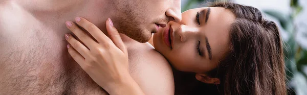 Imagen horizontal de mujer morena tocando novio musculoso y seductor — Stock Photo