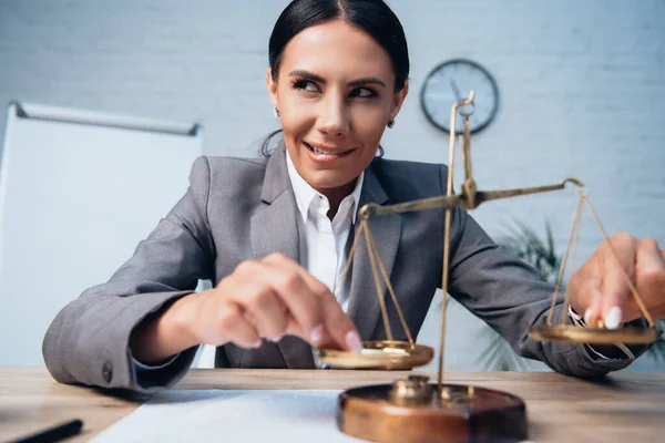 Selective focus of pensive businesswoman in formal wear touching scales and biting lips in office — Stock Photo