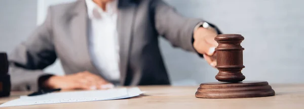 Panoramic shot of judge holding gavel near stethoscope and documents — Stock Photo