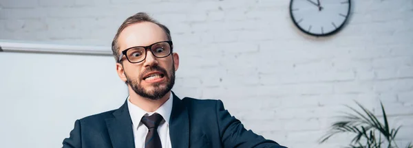 Panoramic crop of bearded businessman in glasses and suit — Stock Photo