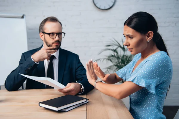 Selective focus of upset client showing stop sign near bearded lawyer in glasses holding document — Stock Photo