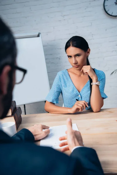 Selective focus of woman looking at lawyer gesturing near insurance contract — Stock Photo