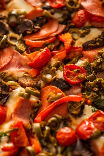 Close up view of delicious Italian pizza with vegetables and salami — Stock Photo