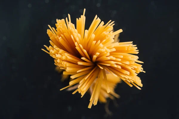 Top view of raw Italian spaghetti isolated on black — Stock Photo