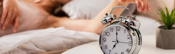 Website header of woman touching retro alarm clock — Stock Photo