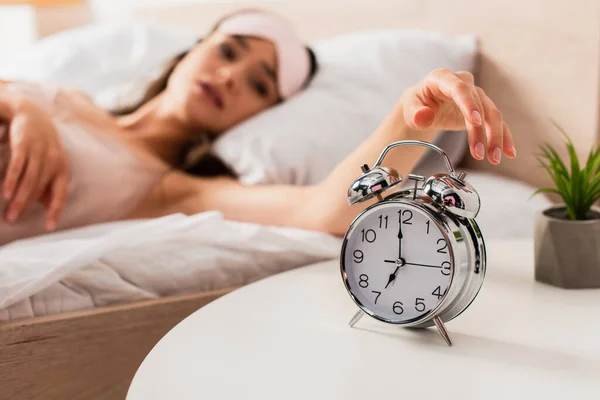 Selective focus of woman touching retro alarm clock — Stock Photo