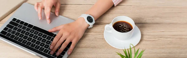 Website header of freelancer using laptop near cup of coffee — Stock Photo